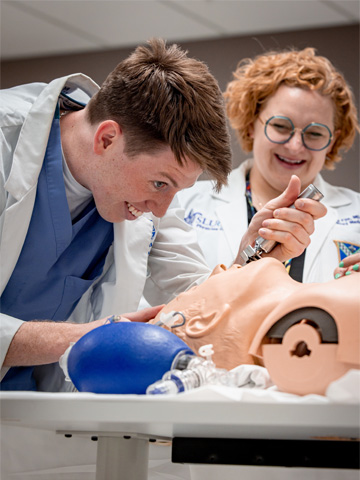 Student working the simulation center One student works with a human simulator.