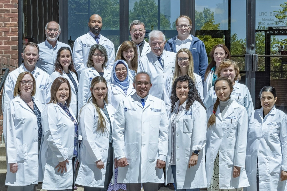 A group photo of the psychiatry faculty standing infront of the LRC