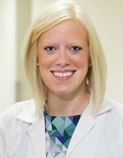 Headshot of Katie Loock, wearing white coat and smiling Headshot of Katie Loock